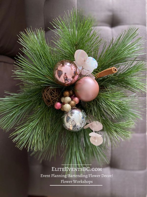 Festive holiday centre piece with evergreens, rose gold and brown accents created by Elena Markin.