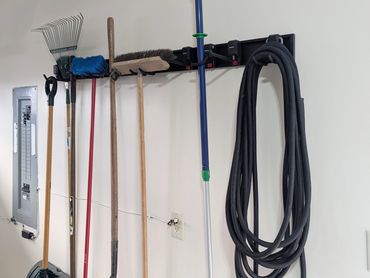 Handyguyz.ca installed a Garage wall with organized gardening tools hanging on hooks.