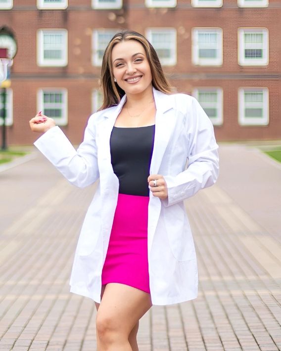 Carla Tretiu on the Winthrop University Campus in a clinical white coat