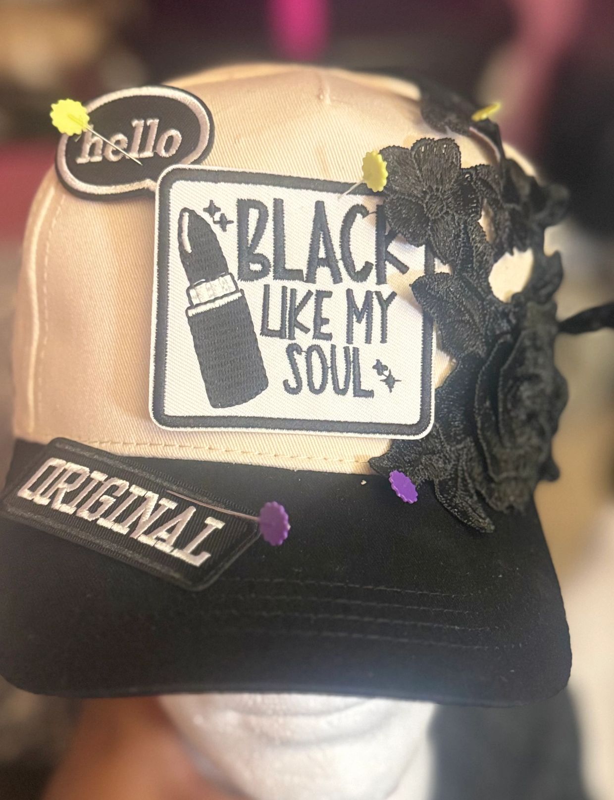 A stylish cap with patches reading 'BLACK LIKE MY SOUL' and 'ORIGINAL'.