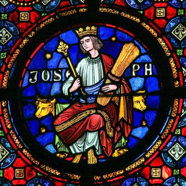Stain glass window of Joseph adorned by Pharaoh, carrying the grains of his dreams that sustain life