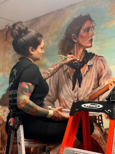 Painting a mural on a ladder