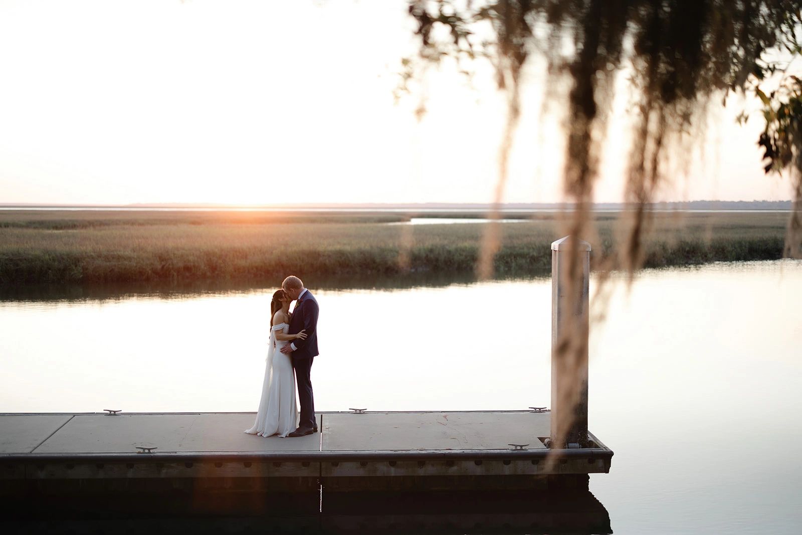 Brooke Images Bride and Groom Kissing on dock at Walkers Landing