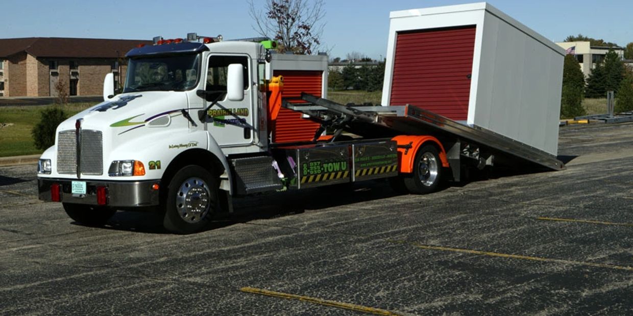 Portable Self Storage Pod being loaded onto a flatbed truck