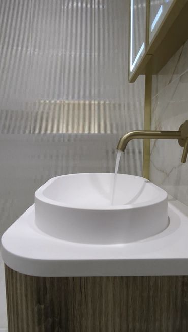 luxury tap with water running in bathroom