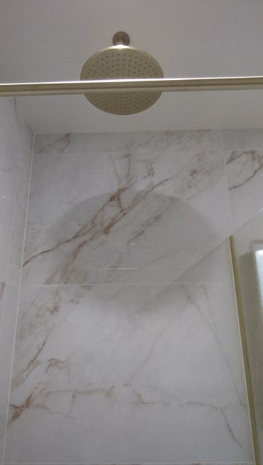 fixed shower head in brushed brass