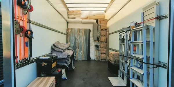 tools and equipment, straps, trolley, moving boxes, sofa in a removals van