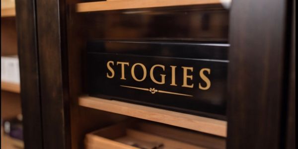 A wooden box labeled 'STOGIES'.