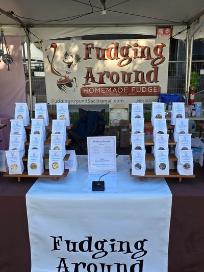 Fudging Around booth selling homemade fudge at an outdoor event.