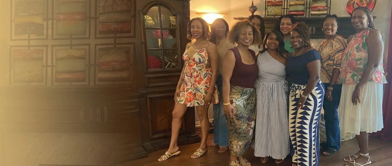Group of nine women posing indoors.