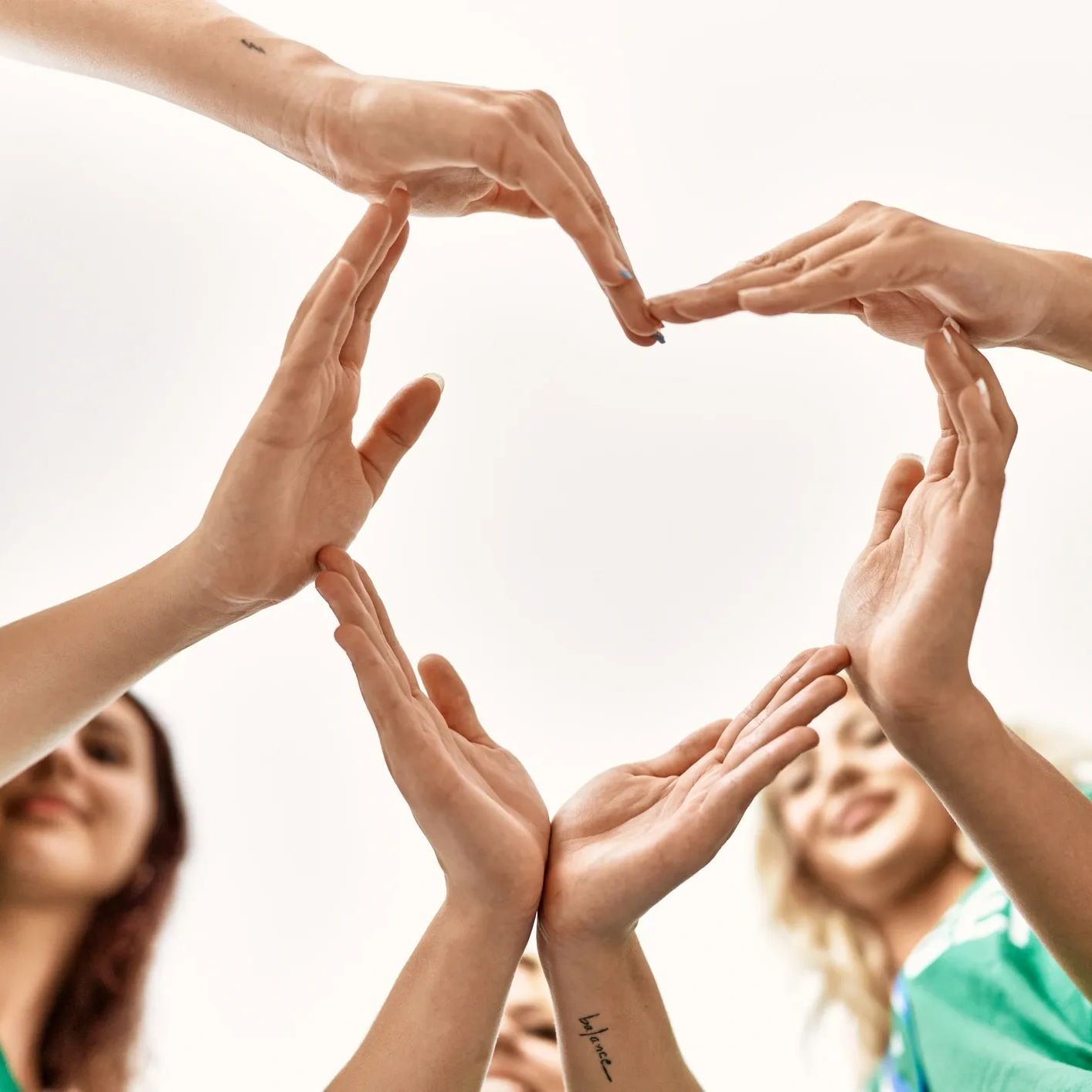 group of girls are putting hands together