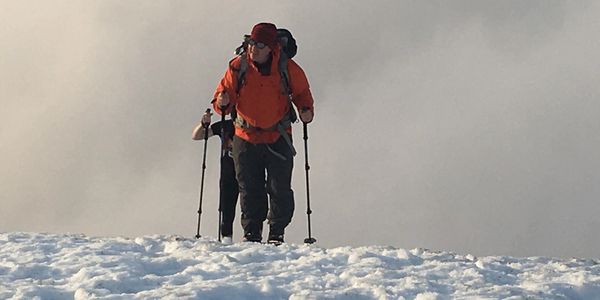 Solo climber climbing snow covered Mount St. Helens