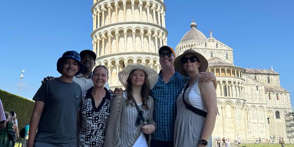 Family and friends together at the Leaning Tower of Pisa.