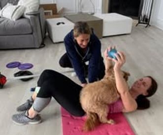 a woman taking a photo with a dog