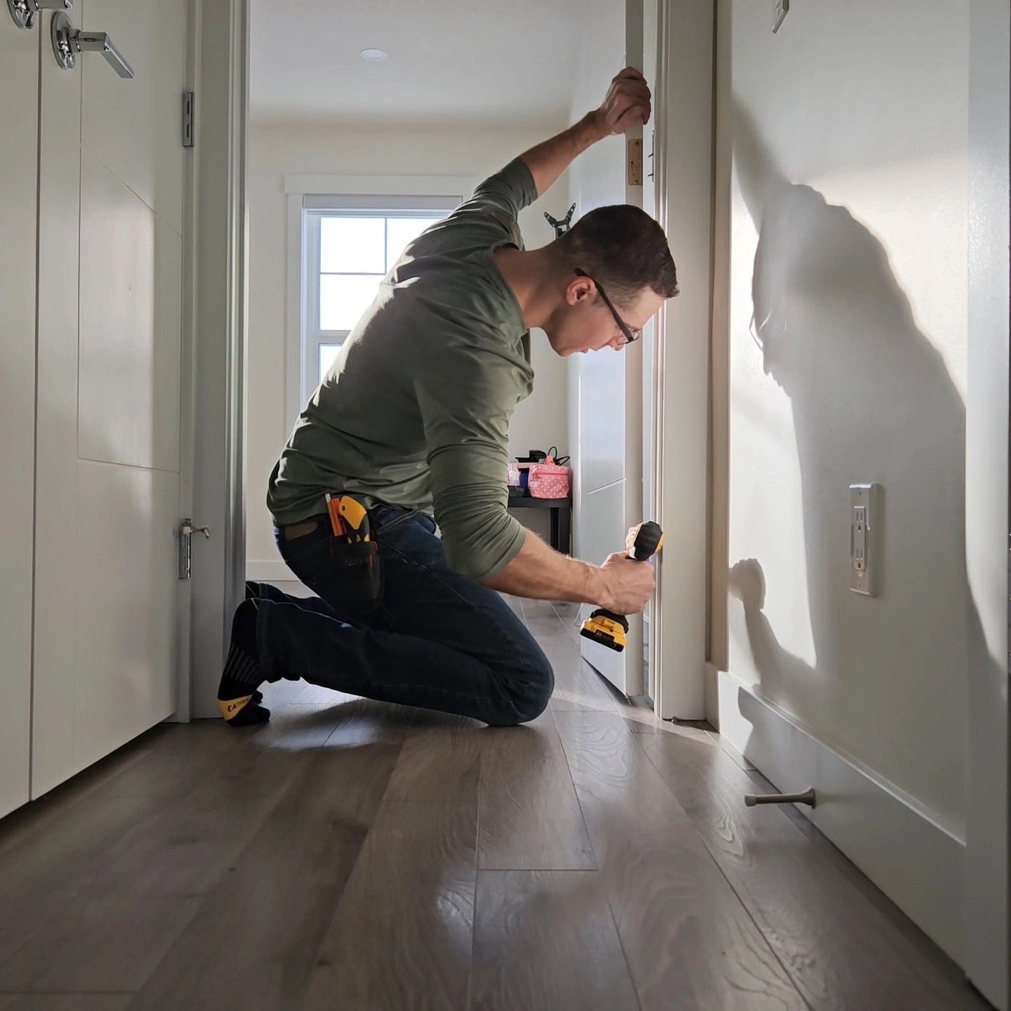 Carpenter repairing interior door during home renovation project showcasing expert carpentry skills