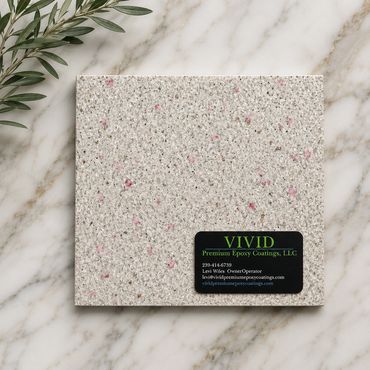 Sample of textured epoxy coating with business card on marble surface.