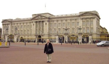 Person standing in front of Buckingham Palace.