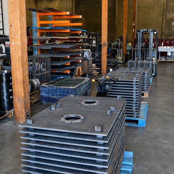 Stacked metal plates in an industrial warehouse.