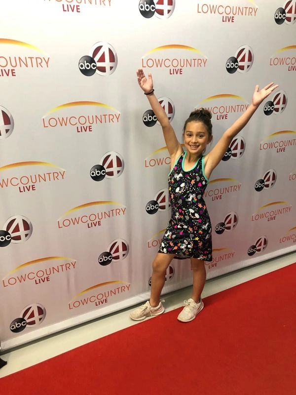 A young girl at a red carpet event