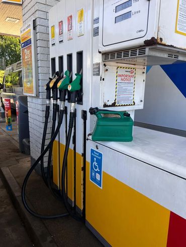 Easyfill no-spill jerry can next to a petrol pump, showing safe filling at the forecourt