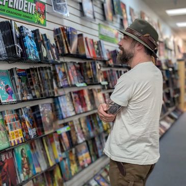 Man browsing comic books in a store.