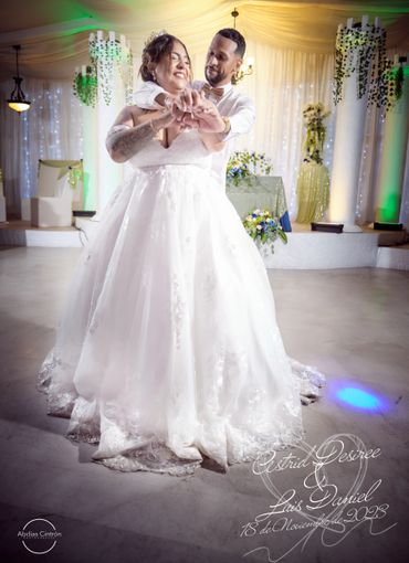 Bride and groom dancing joyfully at their wedding.