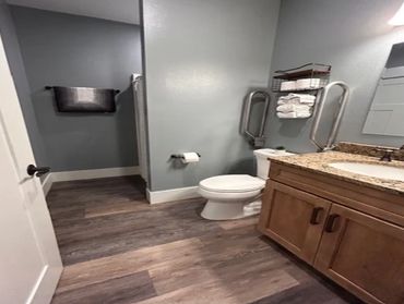 Accessible bathroom with grab bars and walk-in shower at Curtis Hill Estate Senior Living
