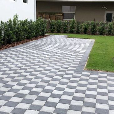 Checkerboard pattern pavers on a driveway.