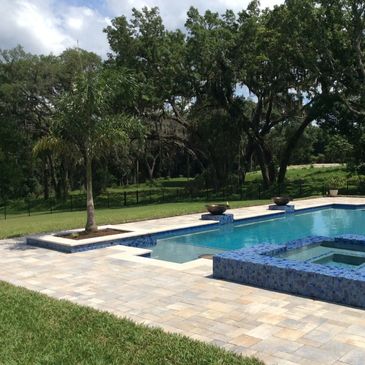 Cream Beige Charcoal pavers installed on a pool deck in Florida.