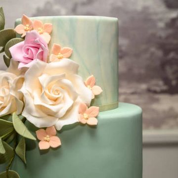green tiered wedding cake with gumpaste flowers
