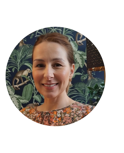 Smiling therapist in a floral top indoors