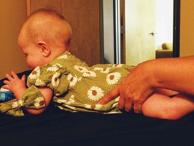 Baby on stomach receiving a baby massage with Craniosacral Fascial Therapy CFT