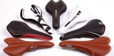 Image shows seven different bicycle saddles
