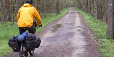 Cyclist riding in wet conditions on the Great Allegheny Passage