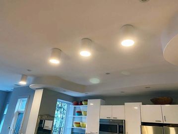 cylinder flush mount pot lights on a modern kitchen ceiling