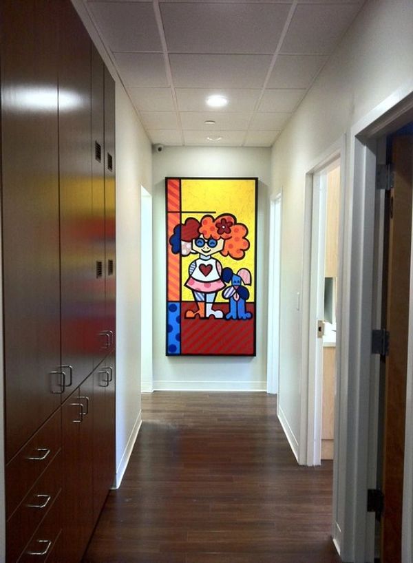 Pediatric dental office with colorful artwork of girl and dog.