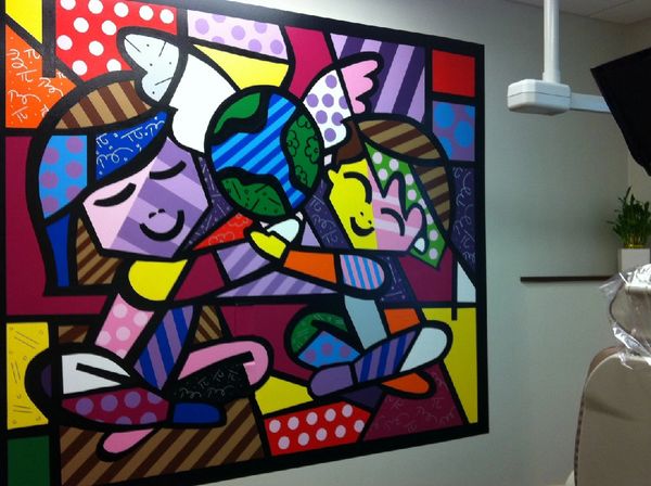 Pediatric dental office with colorful mural of 2 kids.