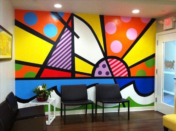Pediatric dental office waiting room with colorful mural.
