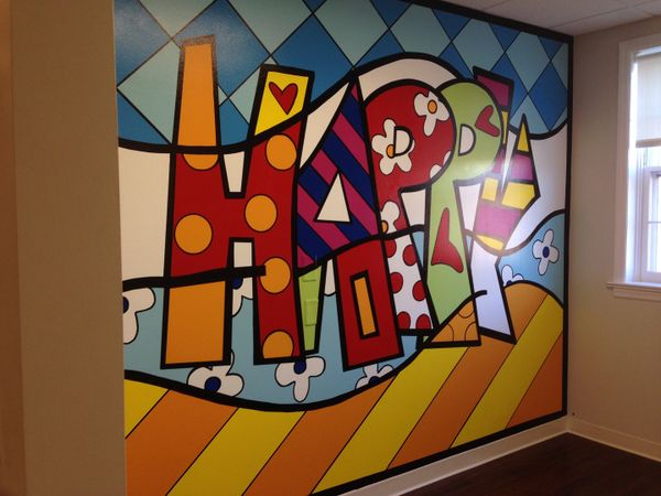 Colorful mural that says "happy" in pediatric dental office.