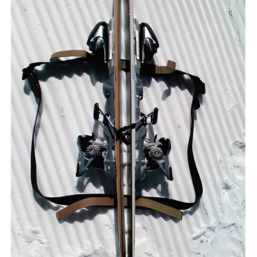 Skis secured with straps, showing how to carry or pack them for transport.