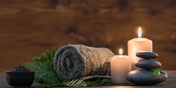 A massage scene with a towel and candles