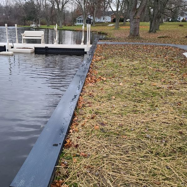 An after photo of a seawall with composite cap and Wave Armor Dock with kayak rack in Akron Ohio.