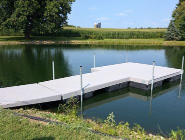 Light Grey composite lumber dock floating in pond.