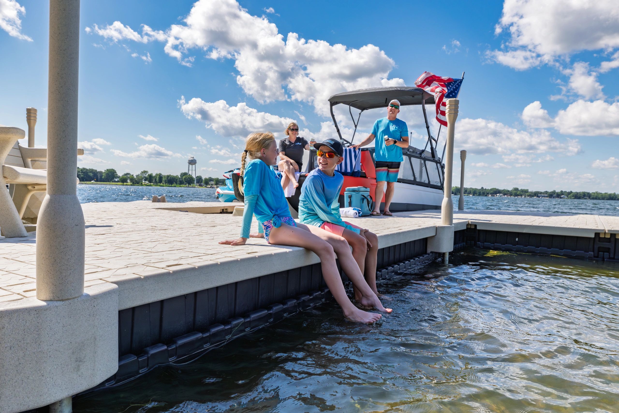 Kids smiling while sitting on the edge of a Wave Armor Floating Dock Portage Lakes Ohio