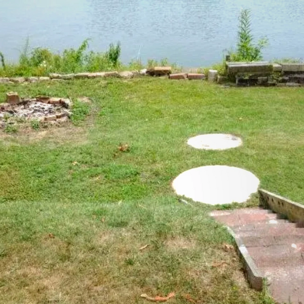 Bricks, steps, round pavers and a lake in the background.