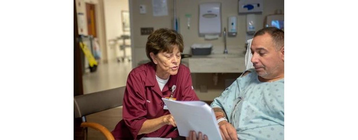 a nurse talking to a patient