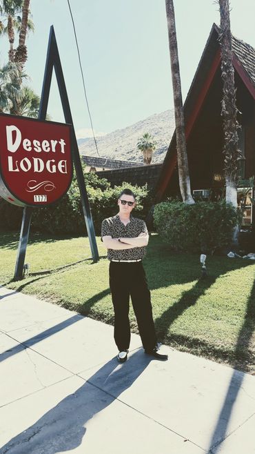 Man posing near Desert Lodge.