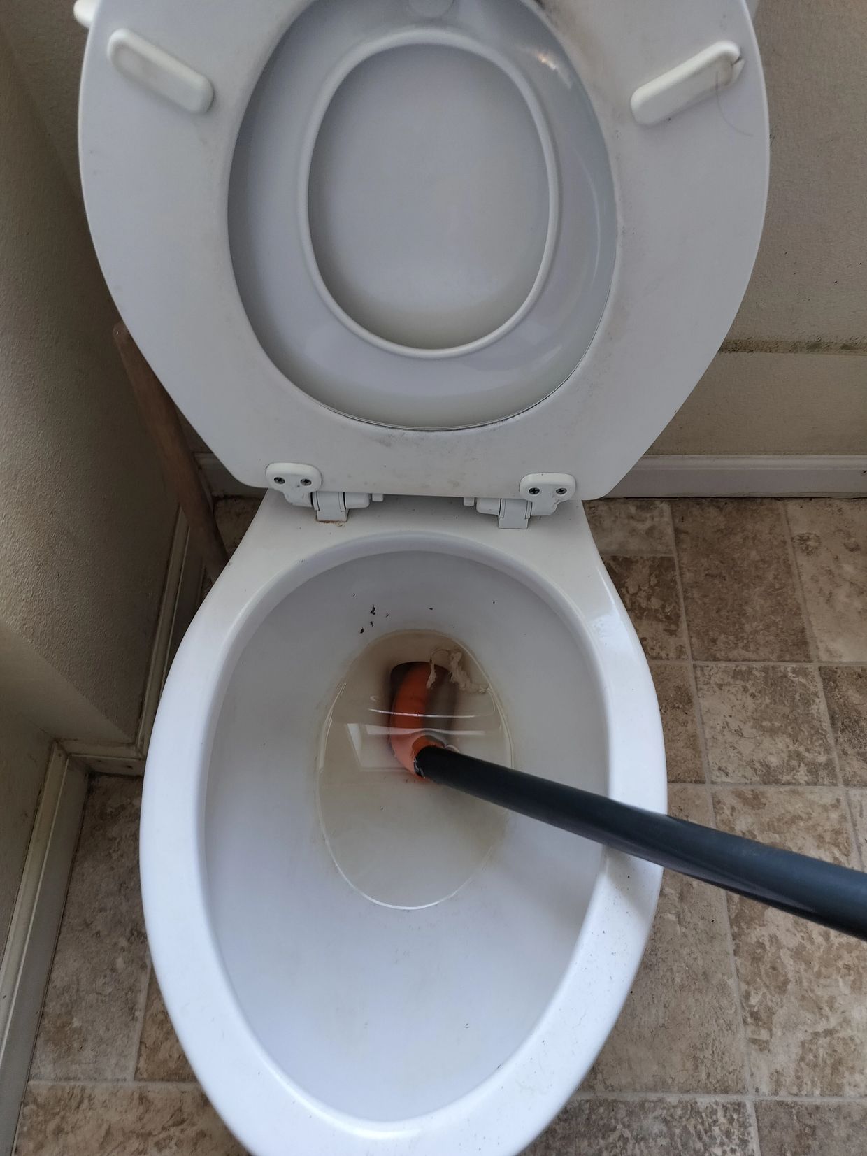 Toilet Auger being used to unclog toilet in Corvallis Oregon 
