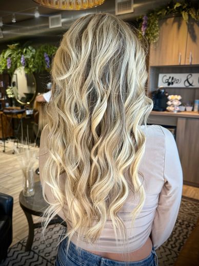 Long wavy blonde hair styled beautifully.