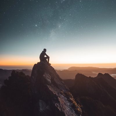a man viewing a spectacular view from the top of the mountain.
